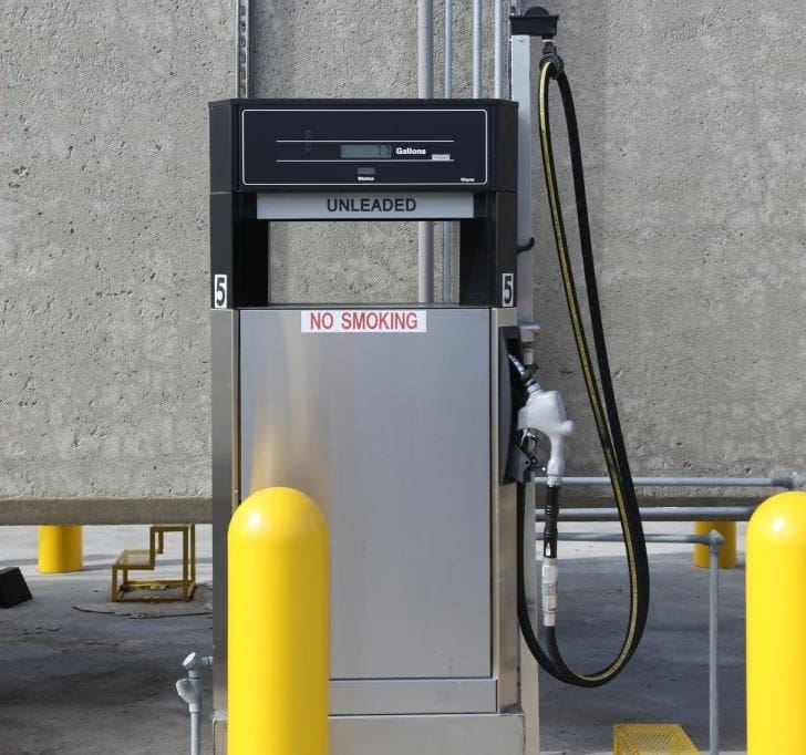 A gas pump is shown next to yellow posts.